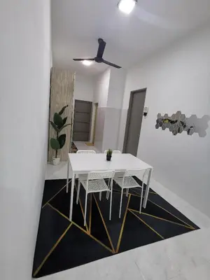 a dining room with a white table and chairs at LYNN HOMESTAY SERI ISKANDAR in Seri Iskandar
