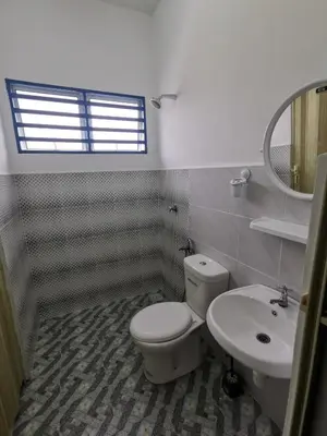 a bathroom with a toilet and a sink at LYNN HOMESTAY SERI ISKANDAR in Seri Iskandar