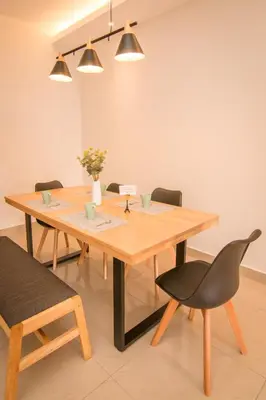 a dining room with a wooden table and chairs at Gorgeous Sunset & Tea Plantation View-Premium Hotel Bed in Kampung Kuala Terla