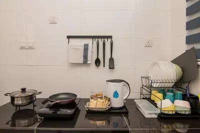 a kitchen counter with a stove and utensils at Gorgeous Sunset & Tea Plantation View-Premium Hotel Bed in Kampung Kuala Terla