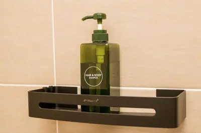 a green bottle of soap in a black soap holder at Gorgeous Sunset & Tea Plantation View-Premium Hotel Bed in Kampung Kuala Terla