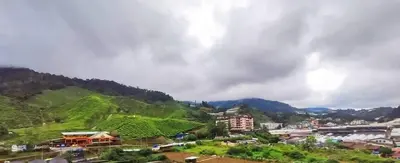 a view of a city with a mountain at Gorgeous Sunset & Tea Plantation View-Premium Hotel Bed in Kampung Kuala Terla