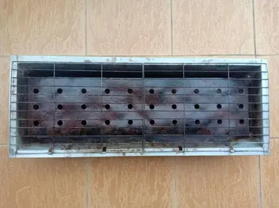 a glass shelf on a wall with black holes at KH Homestay Comfy N Calm in Seri Manjung