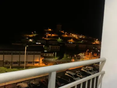 a view of a city at night from a balcony at GUNONG HOMESTAY at Golden Hills CameronHighlands in Cameron Highlands