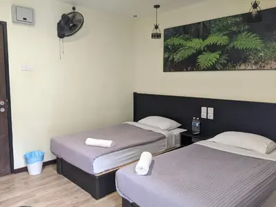 two beds in a hotel room with two bedsvisor at Hillview Inn Cameron Highlands PROMO in Tanah Rata
