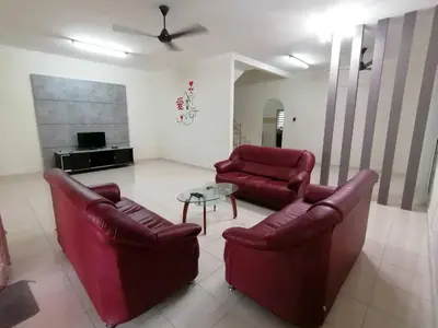a living room with two red chairs and a table at \u7231\u6c11\u5bbf Love House in Sitiawan