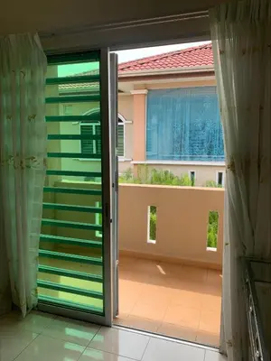 a sliding glass door with a view of a balcony at \u7231\u6c11\u5bbf Love House in Sitiawan