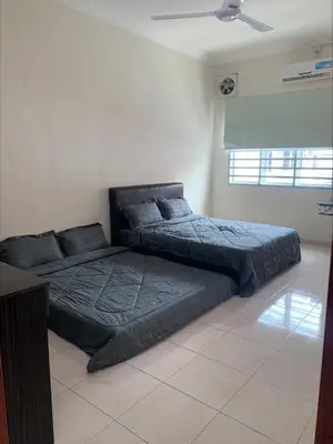 a bedroom with two beds and a ceiling at \u7231\u6c11\u5bbf Love House in Sitiawan