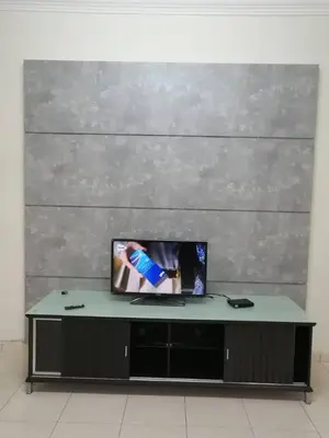 a flat screen tv sitting on top of a table at \u7231\u6c11\u5bbf Love House in Sitiawan