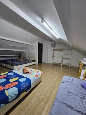 a room with three beds in a room at Color Mixed Home Hostel in George Town