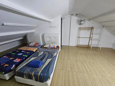 a room with a bed and a ladder in it at Color Mixed Home Hostel in George Town