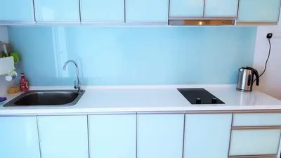 a kitchen with white cabinets and a sink at Mansion One Peaceful Homestay in George Town