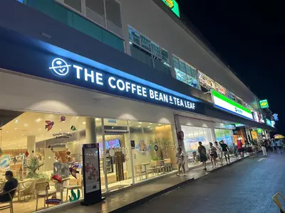 a store front of a coffee bean theatre at night at Beach Resort 7 Home Stay SRI SAYANG APARTMENT BATU FERRINGHI 3BEDROOM in Batu Ferringhi