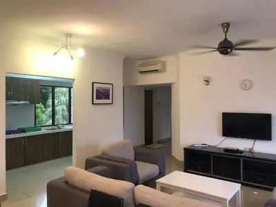 a living room with a couch and a flat screen tv at Beach Resort 7 Home Stay SRI SAYANG APARTMENT BATU FERRINGHI 3BEDROOM in Batu Ferringhi