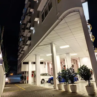 a building with a car parked in a parking lot at Aurora Court Service Apartment in George Town