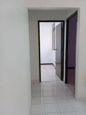 an empty room with a door and a tile floor at Homestay Idaman Penang in Permatang Pauh