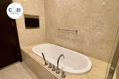 a bathroom with a bath tub with a sink at Instagramable Luxury Suites for Couples or Families • Straits Quay Penang • Sea View Balcony • Private Bathtub in Bagan Jermal