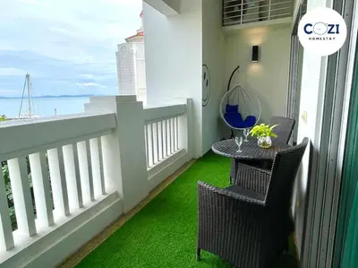 a balcony with a table and chairs with a view of the ocean at Instagramable Luxury Suites for Couples or Families • Straits Quay Penang • Sea View Balcony • Private Bathtub in Bagan Jermal