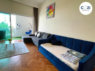 a living room with a blue couch and a table at Instagramable Luxury Suites for Couples or Families • Straits Quay Penang • Sea View Balcony • Private Bathtub in Bagan Jermal