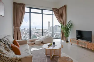 a living room with a couch and a large window at Beacon Executive Suites by Simply Penang in George Town