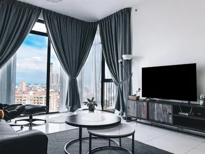 a living room with a flat screen tv and large windows at Beacon Executive Suites by Simply Penang in George Town