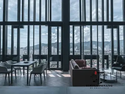 a living room with a couch and a table and chairs at Beacon Executive Suites by Simply Penang in George Town