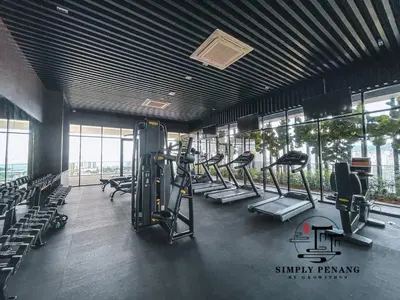 a gym with rows of treadmills and elliptical machines at Beacon Executive Suites by Simply Penang in George Town
