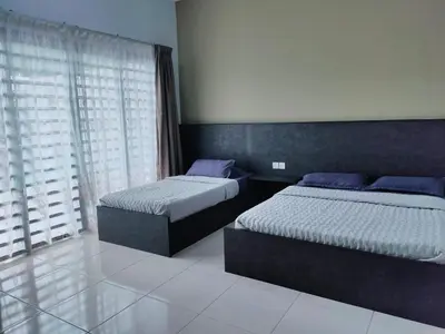 a bedroom with two beds and a window at IPOH staycation in Ipoh