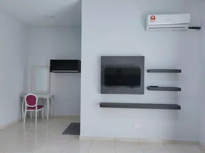 a white room with a fireplace and a red chair at IPOH staycation in Ipoh