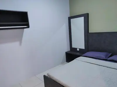 a bedroom with a bed and a mirror in it at IPOH staycation in Ipoh