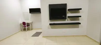 a room with a flat screen tv on a wall at IPOH staycation in Ipoh