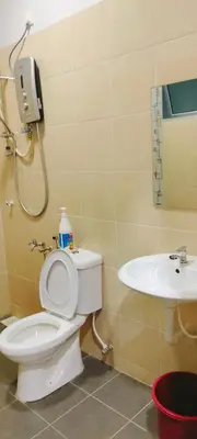 a bathroom with a toilet and a sink at IPOH staycation in Ipoh