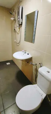 a bathroom with a toilet and a sink and a mirror at IPOH staycation in Ipoh