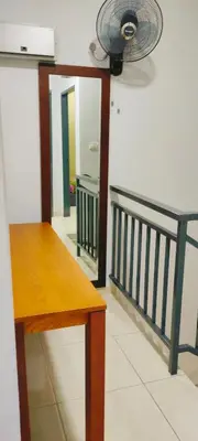 a room with a table and a fan and a mirror at IPOH staycation in Ipoh