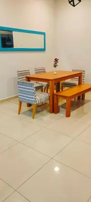 a wooden table and two benches and a table and chairs at IPOH staycation in Ipoh
