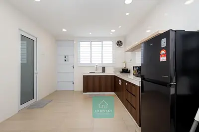 a kitchen with a black refrigerator and a sink at Jomstay MUJI 19 & 7 INN Ipoh Garden 8-10 pax in Ipoh