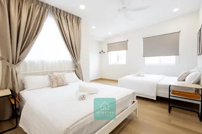 a bedroom with two beds and a window at Jomstay MUJI 19 & 7 INN Ipoh Garden 8-10 pax in Ipoh
