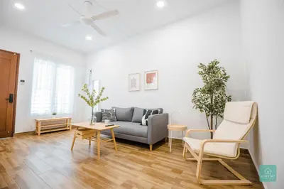 a living room with a couch and a table at Jomstay MUJI 19 & 7 INN Ipoh Garden 8-10 pax in Ipoh