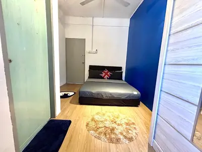 a bedroom with a bed and a blue wall at Entire Residential House Alma Bukit Mertajam Spacious 4 bedroom in Bukit Mertajam