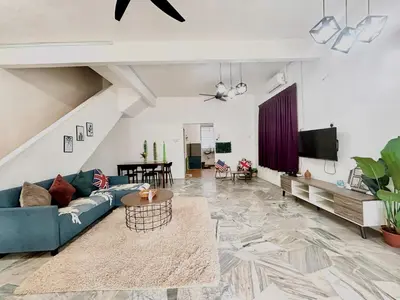 a living room with a blue couch and a tv at Entire Residential House Alma Bukit Mertajam Spacious 4 bedroom in Bukit Mertajam