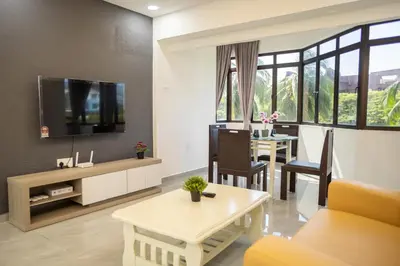 a living room with a couch and a table at Sri Sayang Seaview Holiday Home in Batu Ferringhi