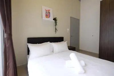 a bedroom with a white bed with white pillows at PLAY at Palas Horizon @ Kea Farm in Cameron Highlands