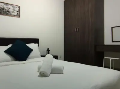 a white bed with a stuffed animal on top of it at PLAY at Palas Horizon @ Kea Farm in Cameron Highlands