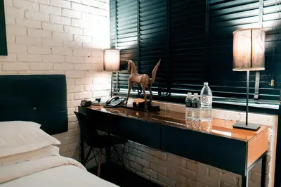 a bedroom with a desk with a horse statue on it at M Boutique Hotel in Ipoh