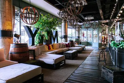 a store with couches and tables in a room with windows at M Boutique Hotel in Ipoh