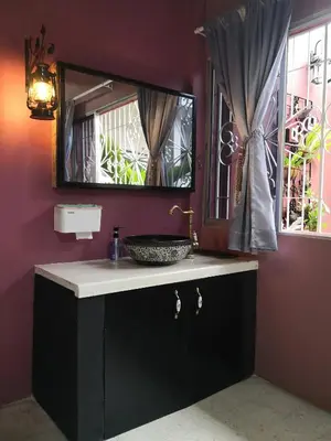 a bathroom with a sink and a mirror at H&T Vintage Decor Homestay in Ipoh