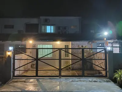 a gate in front of a house at night at H&T Vintage Decor Homestay in Ipoh