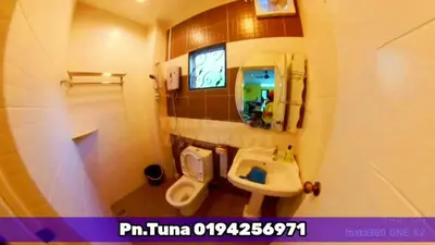 a bathroom with a sink and a toilet and a mirror at Tuna Cameron Homstay in Brinchang