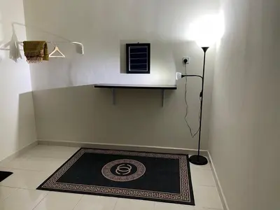 a room with a rug on the floor and a lamp at No 61 Nazirin Homestay Tmn Indah Raya 2 Manjung Lumut in Lumut