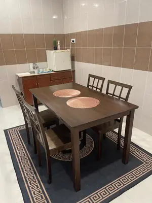 a wooden table and chairs in a kitchen at No 61 Nazirin Homestay Tmn Indah Raya 2 Manjung Lumut in Lumut